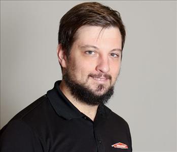 Male employee with brown hair and beard.